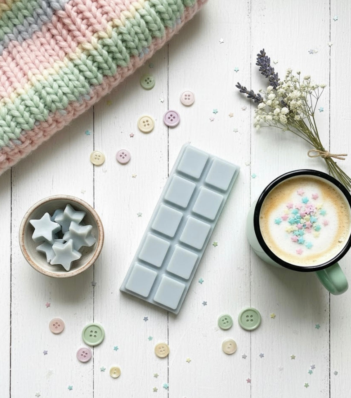 Wax melt Snapbar with star shapes on a white surface with a mug of coffee and decorative elements.
